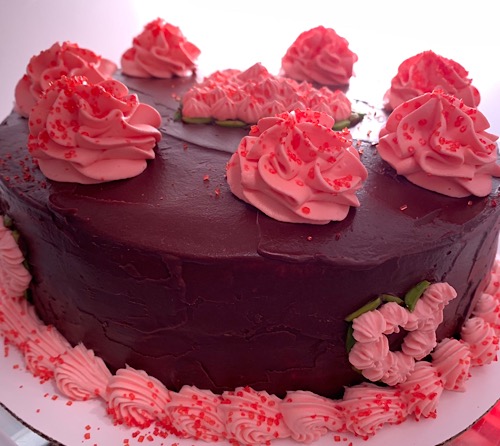 vanilla cake with chocolate glaze and whipped cream